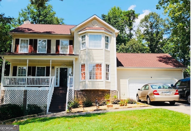 view of front of house with covered porch and a garage