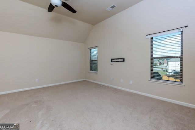 unfurnished room featuring ceiling fan, light carpet, and lofted ceiling