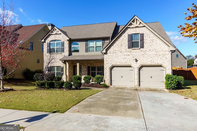 view of front of house with a garage and a front lawn