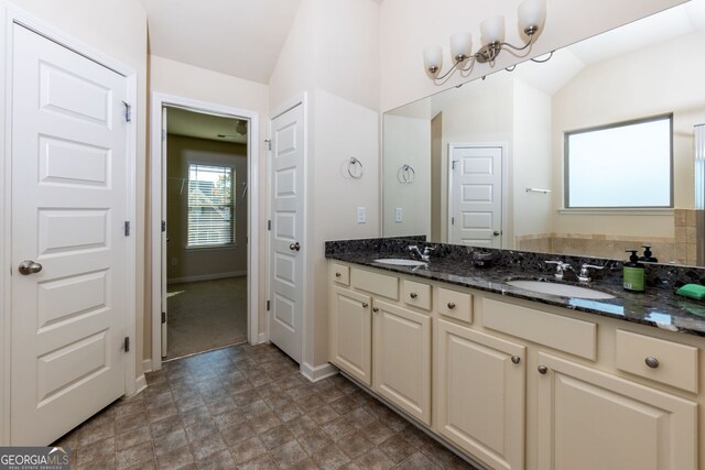 bathroom with vanity and vaulted ceiling