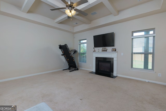 unfurnished living room with beamed ceiling, ceiling fan, light colored carpet, and coffered ceiling