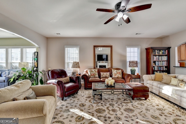 living room with ceiling fan and a healthy amount of sunlight