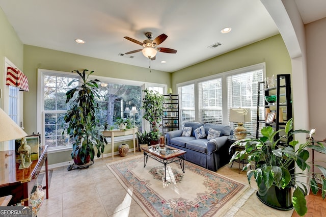 living room with ceiling fan, plenty of natural light, and light tile patterned floors