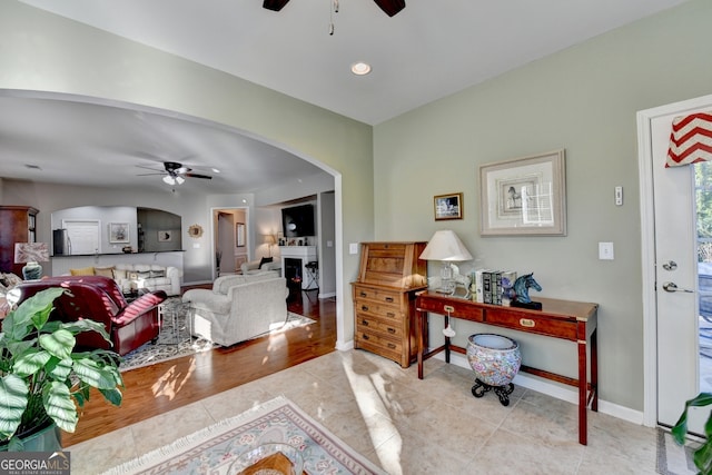 living room with light hardwood / wood-style floors and ceiling fan