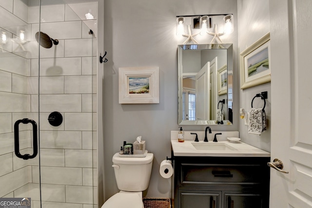 bathroom with vanity, toilet, and walk in shower