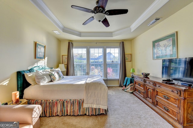 bedroom with a tray ceiling, ceiling fan, crown molding, and light colored carpet