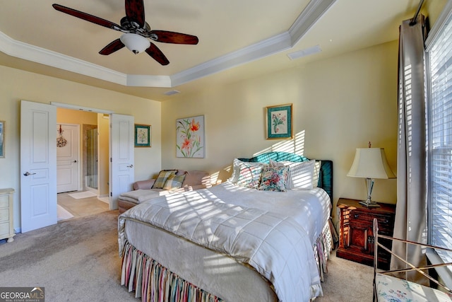 bedroom featuring light carpet, a tray ceiling, ceiling fan, and ornamental molding