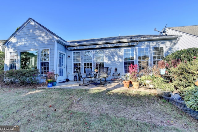 back of house featuring a patio area and a yard