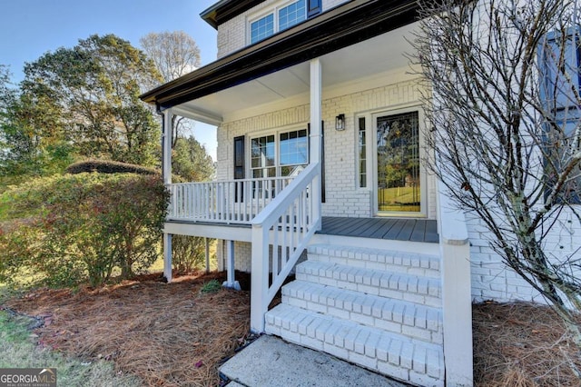 view of exterior entry with a porch