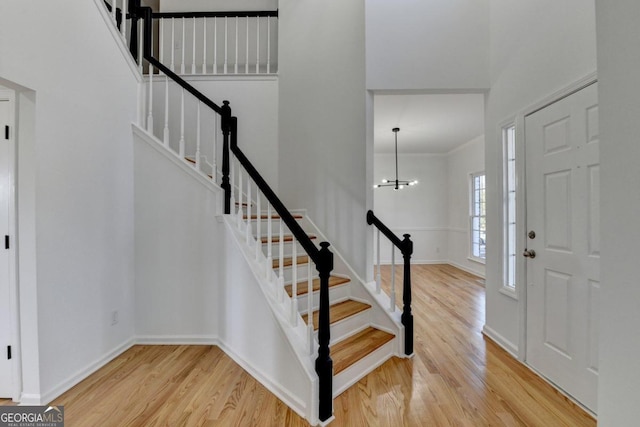 foyer entrance featuring an inviting chandelier and light hardwood / wood-style flooring