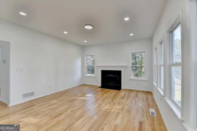 unfurnished living room with plenty of natural light and light wood-type flooring