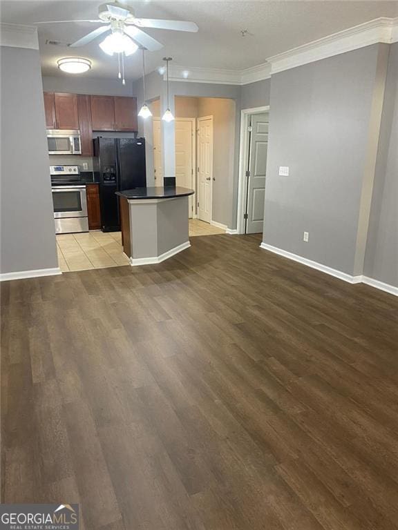 kitchen with ornamental molding, light hardwood / wood-style flooring, hanging light fixtures, and appliances with stainless steel finishes