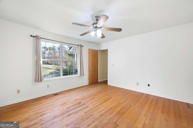 unfurnished room featuring ceiling fan and light hardwood / wood-style floors