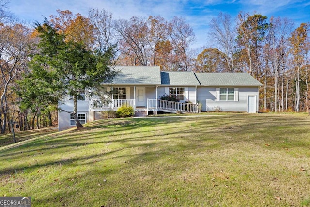 ranch-style house featuring a front yard and covered porch