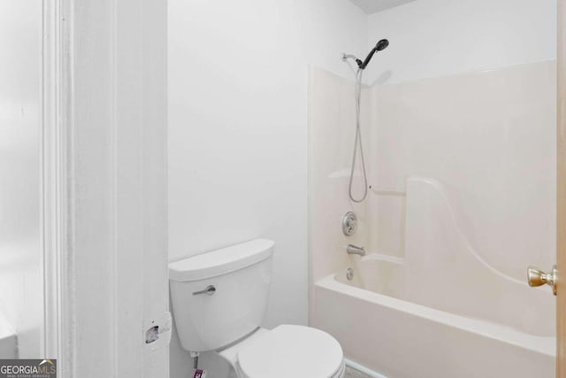 bathroom with shower / bath combination and toilet