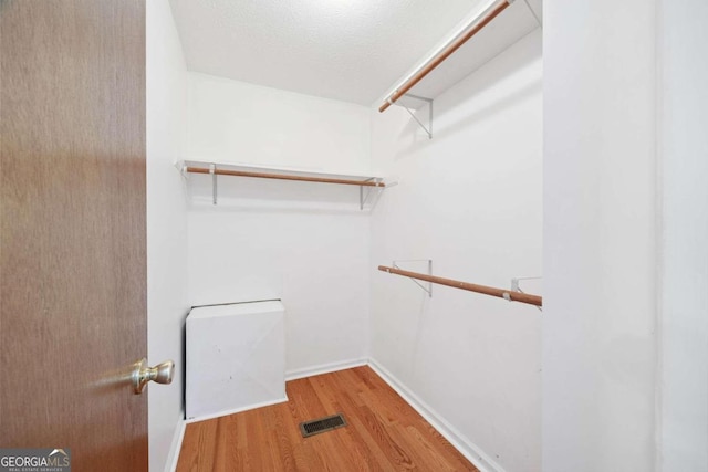 spacious closet featuring hardwood / wood-style floors