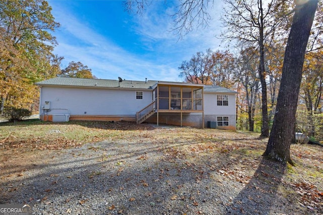 rear view of house featuring a sunroom