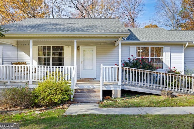 view of exterior entry with a porch