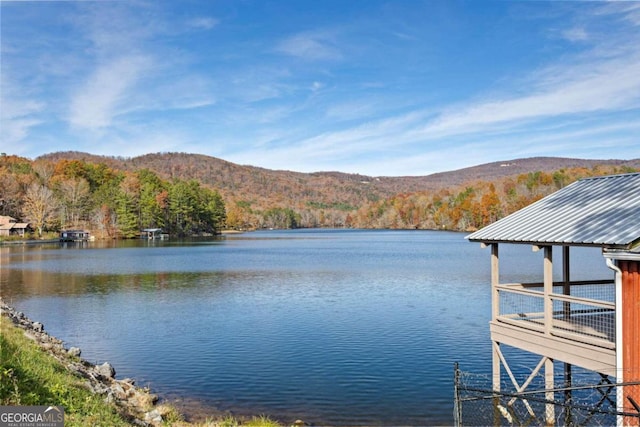 view of dock with a water and mountain view