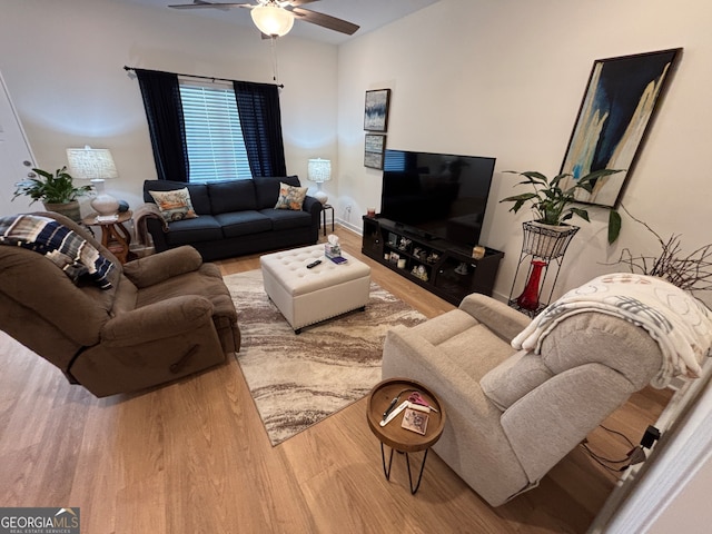 living room featuring hardwood / wood-style floors and ceiling fan