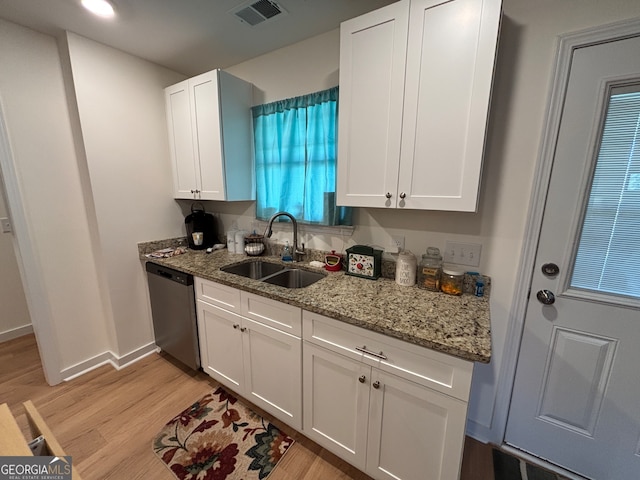 kitchen featuring dishwasher, light wood-type flooring, white cabinets, and sink