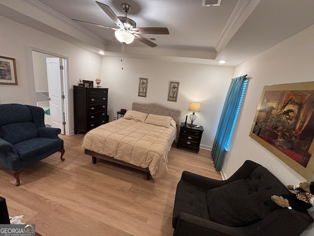 bedroom with light hardwood / wood-style floors, ceiling fan, and crown molding