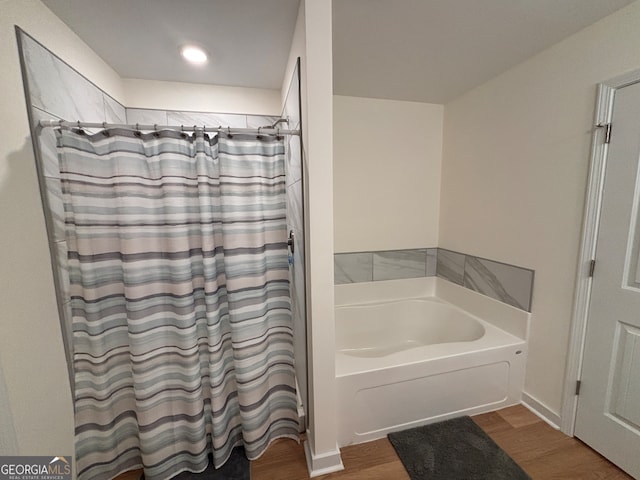 bathroom with plus walk in shower and wood-type flooring