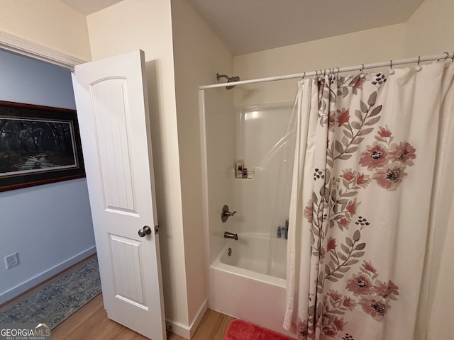 bathroom featuring shower / tub combo and hardwood / wood-style flooring