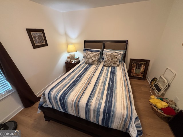 bedroom with hardwood / wood-style floors