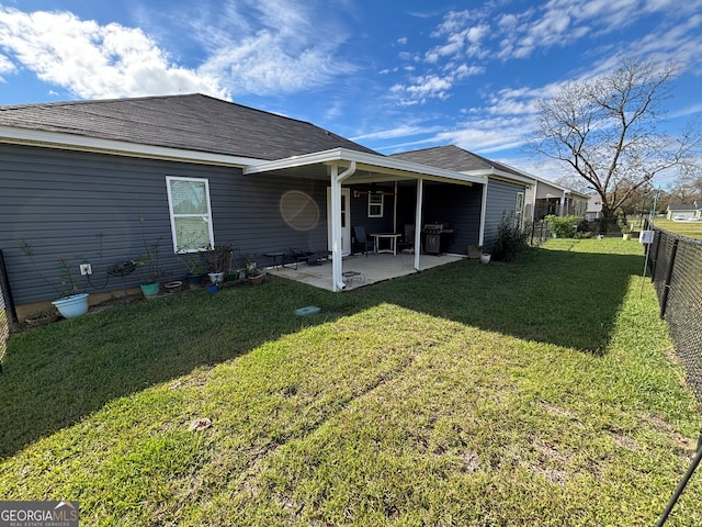 rear view of property featuring a yard and a patio