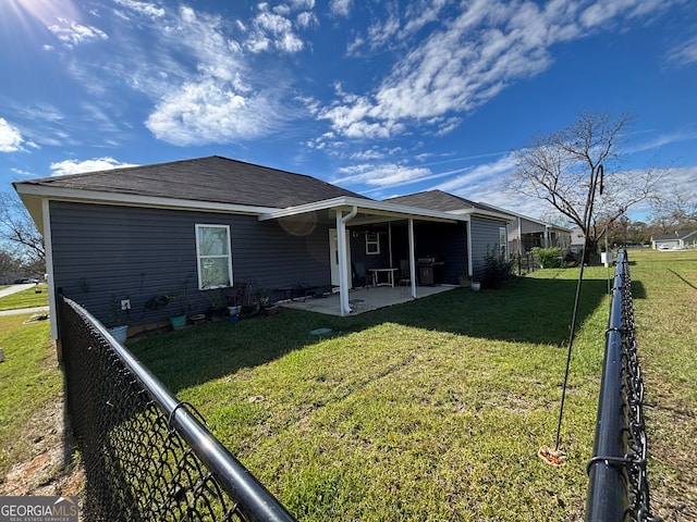 back of property featuring a yard and a patio area