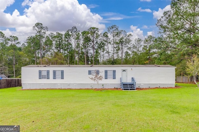 rear view of house with a yard