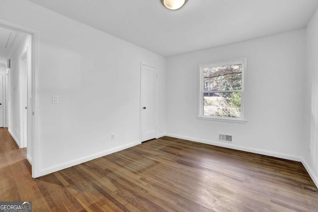 spare room with dark hardwood / wood-style floors