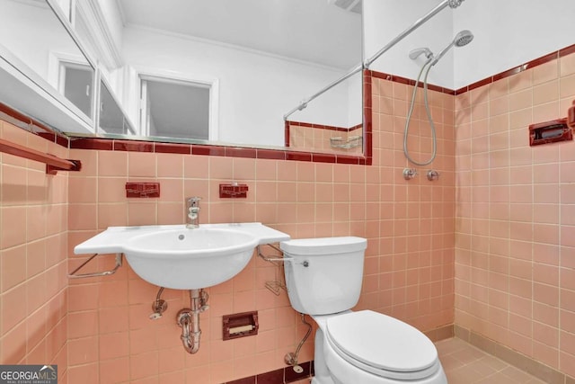 bathroom featuring decorative backsplash, tile walls, toilet, and tiled shower