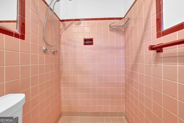 bathroom with a tile shower