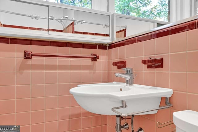 bathroom featuring a wealth of natural light, tile walls, and decorative backsplash