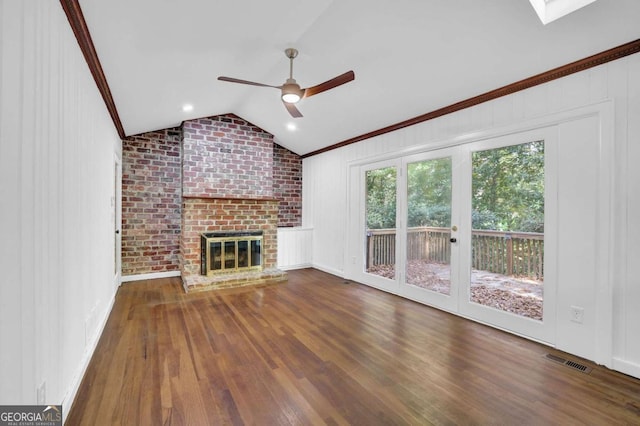 unfurnished living room featuring crown molding, ceiling fan, hardwood / wood-style flooring, a fireplace, and lofted ceiling