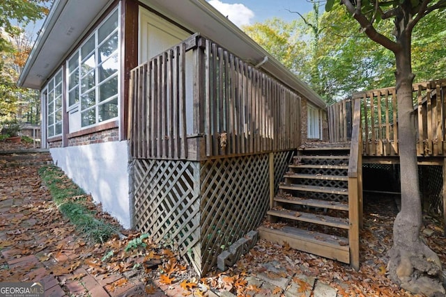 view of property exterior featuring a wooden deck