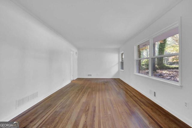 spare room featuring dark hardwood / wood-style flooring