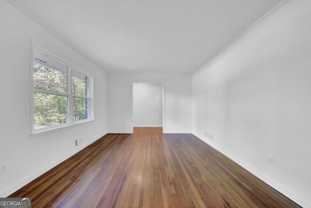 spare room with dark hardwood / wood-style flooring