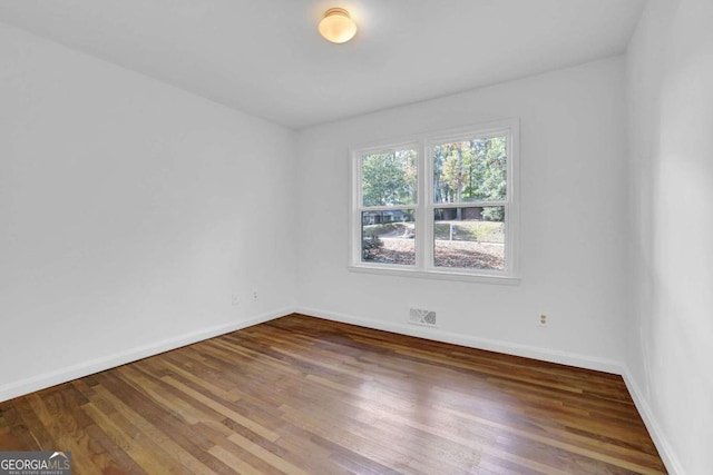 empty room with hardwood / wood-style floors