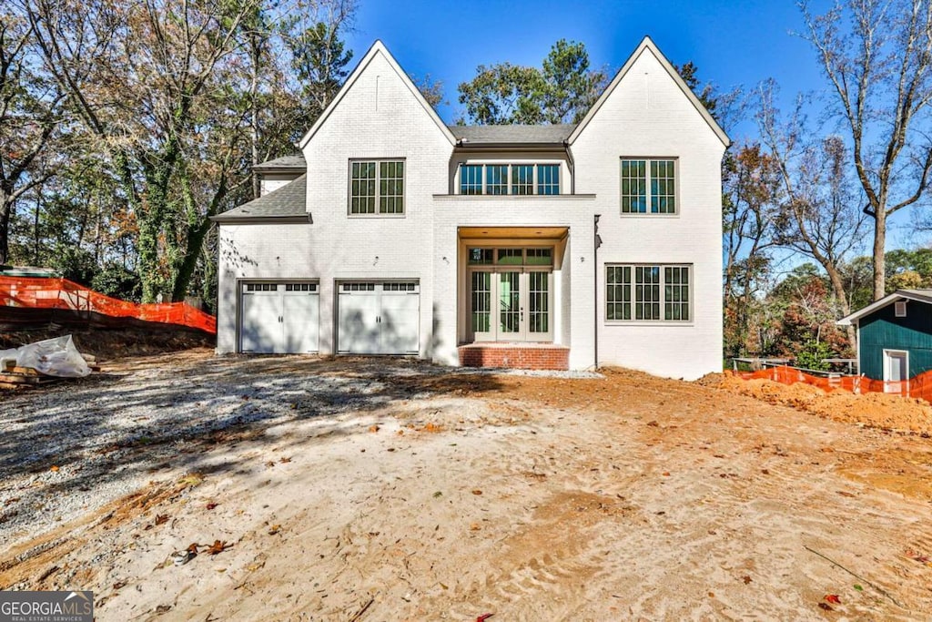 view of front of property featuring a garage and french doors