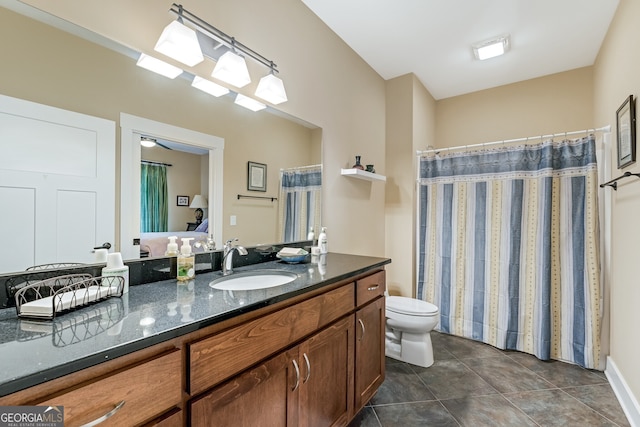 bathroom featuring tile patterned flooring, vanity, and toilet