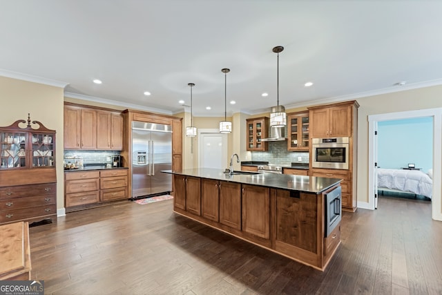 kitchen with built in appliances, decorative light fixtures, dark hardwood / wood-style flooring, and tasteful backsplash