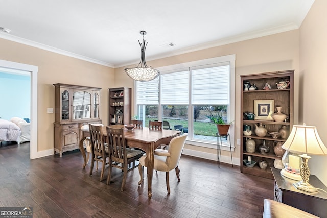 dining room with dark hardwood / wood-style flooring and crown molding