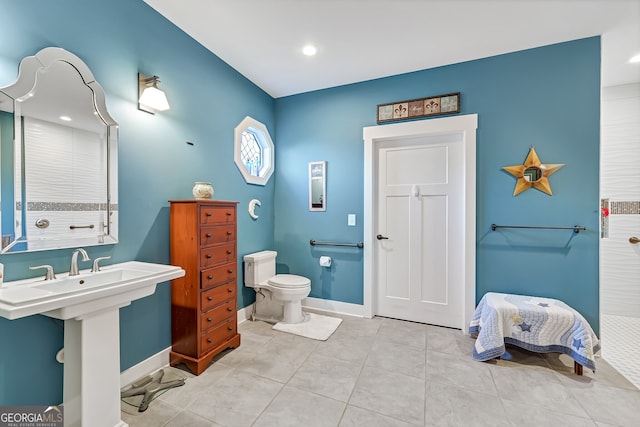 bathroom with tile patterned floors, toilet, and sink