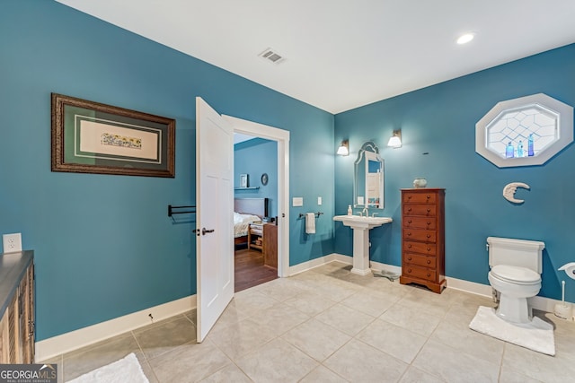 bathroom with tile patterned floors and toilet