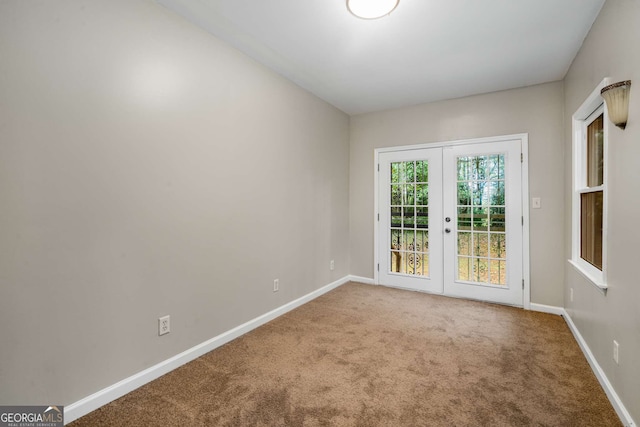 unfurnished room with carpet flooring and french doors