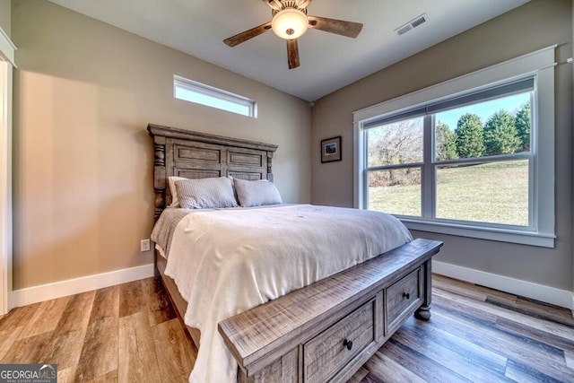 bedroom with ceiling fan and light hardwood / wood-style flooring