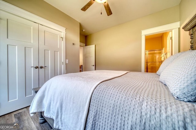 bedroom with a closet, hardwood / wood-style flooring, and ceiling fan